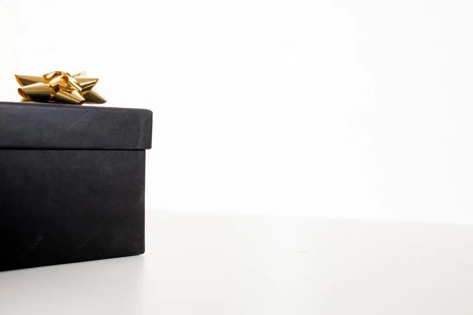 Black gift box with gold bow