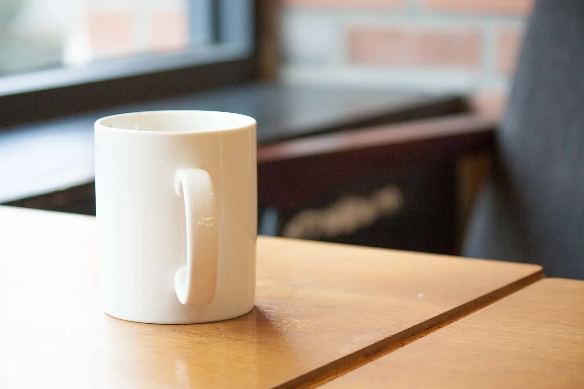 White ceramic mug on a café table